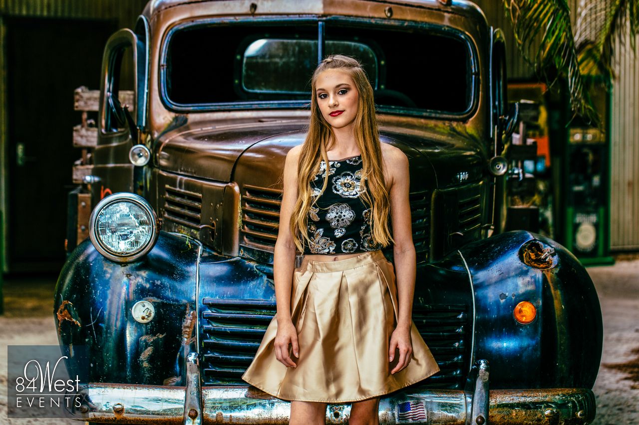 girl in front of vintage automobile