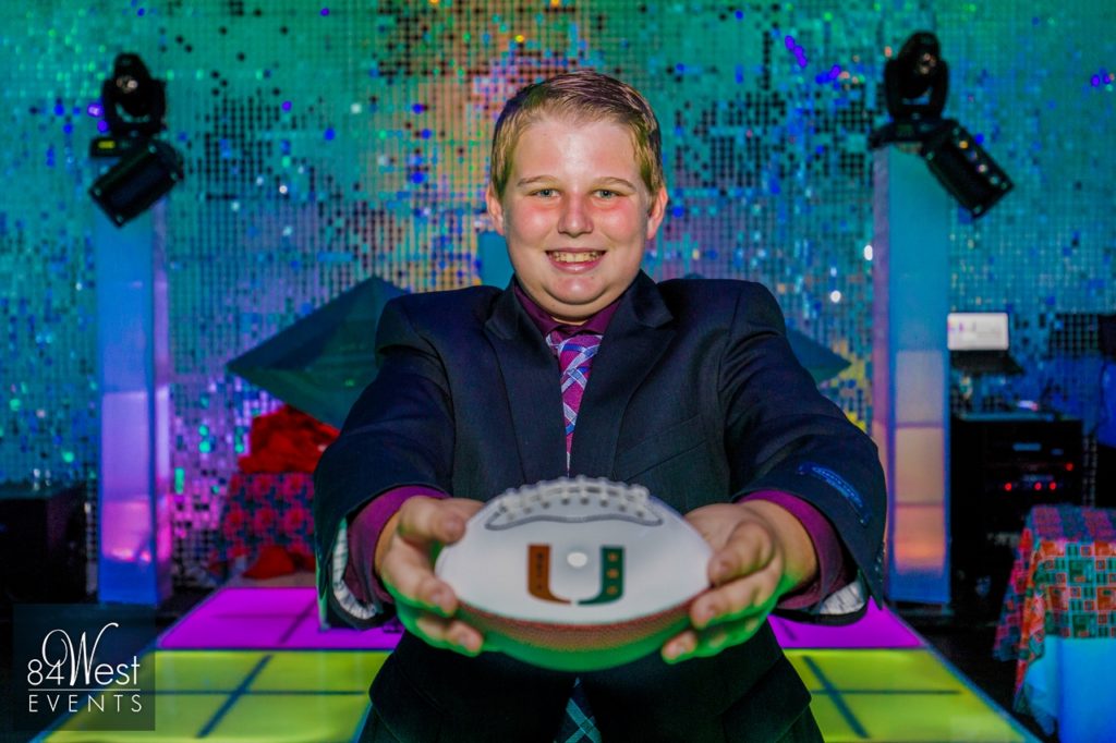 boy posing with football