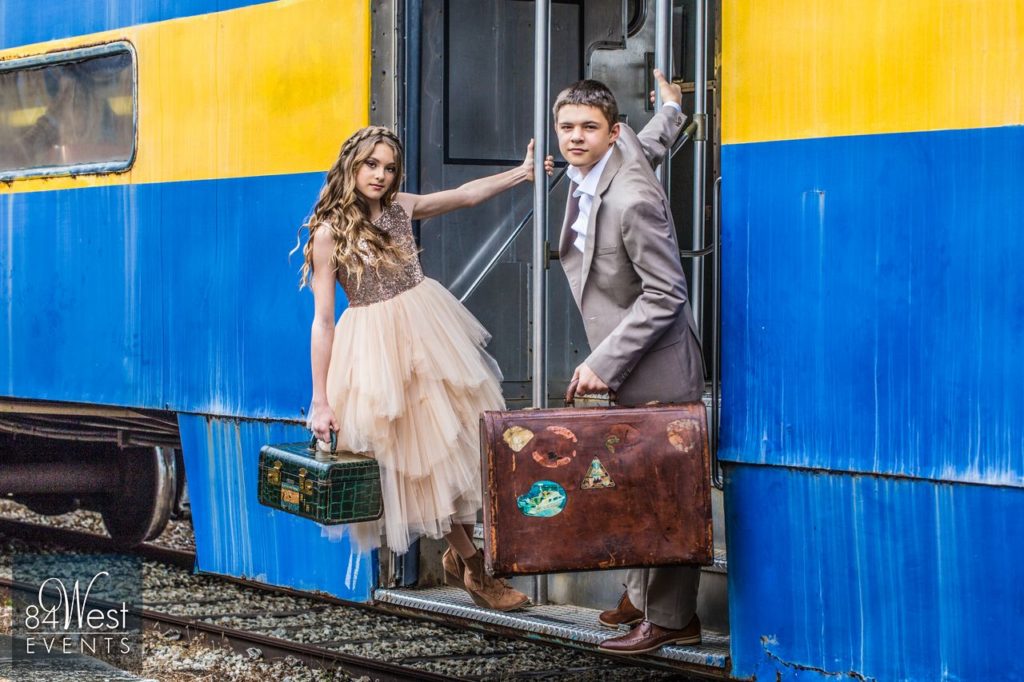 kids posing with suitcases