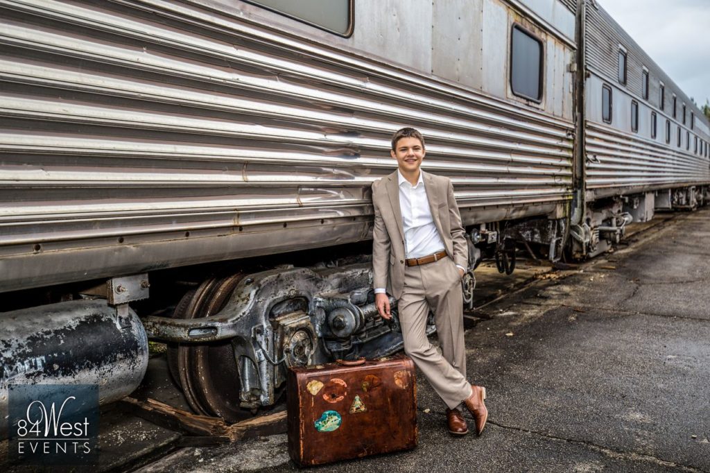 boy posing by train