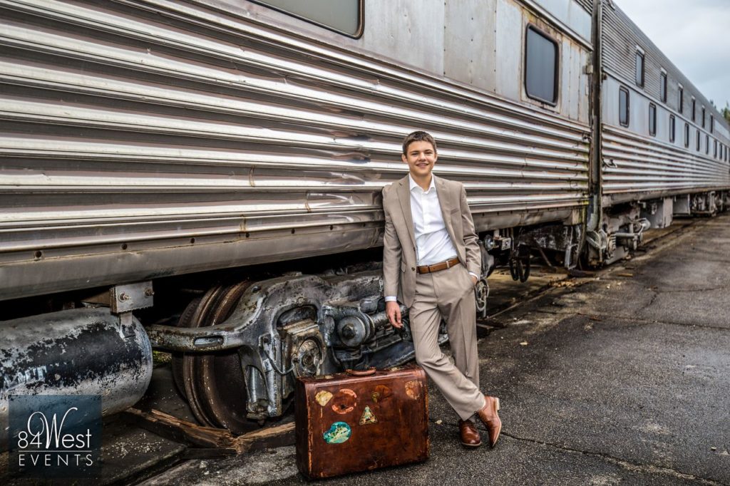 boy posing by train