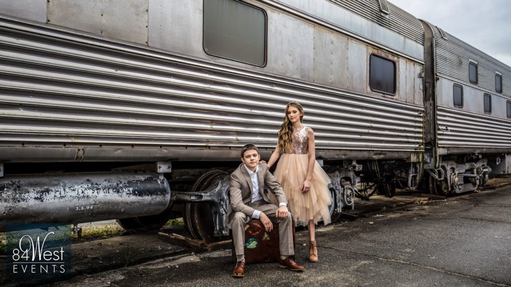 boy and girl take picture with suitcases