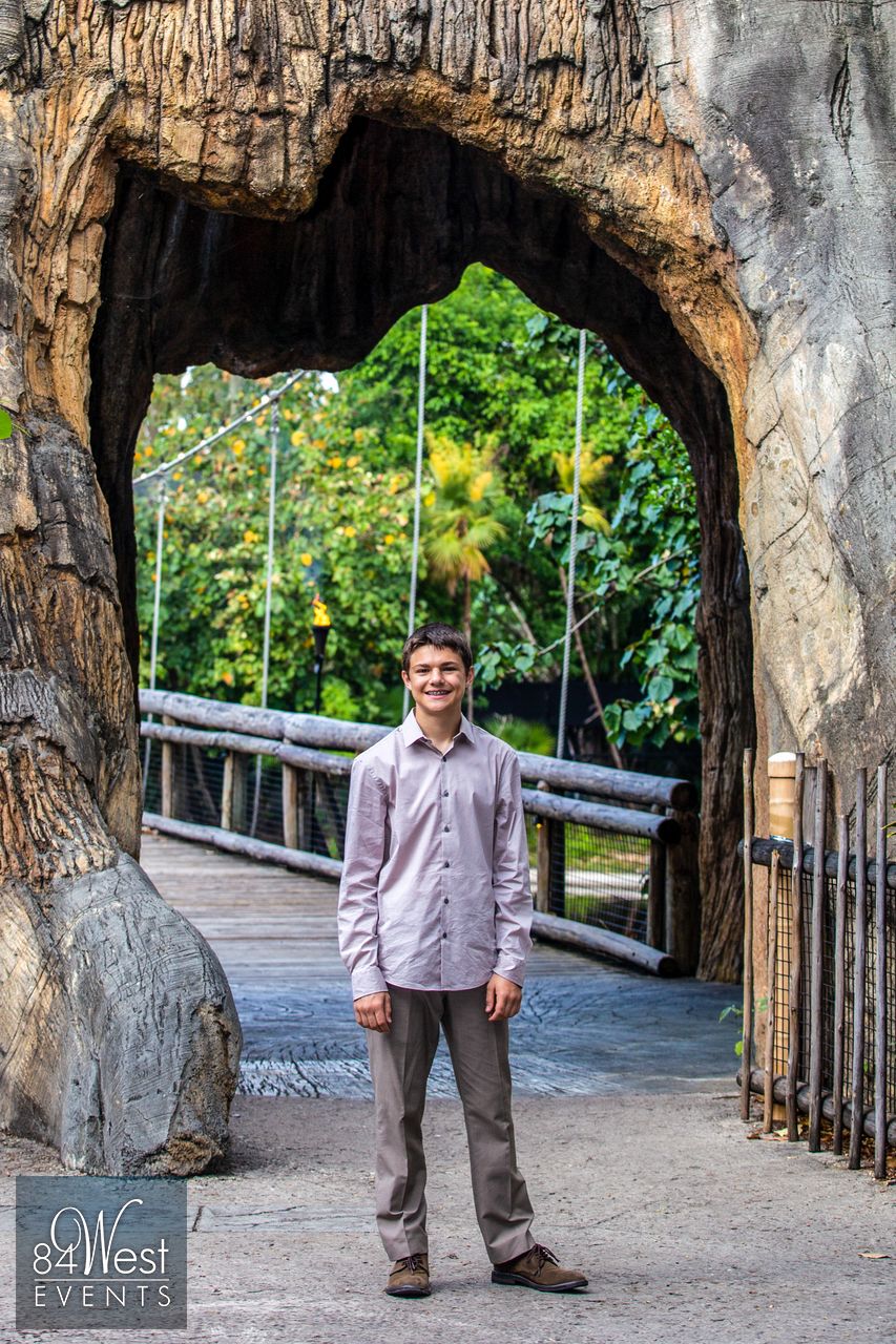 boy under stone structure